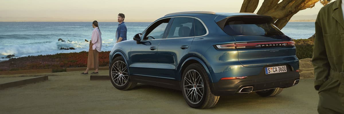 Blue Porsche Cayenne Parked Next to Coast