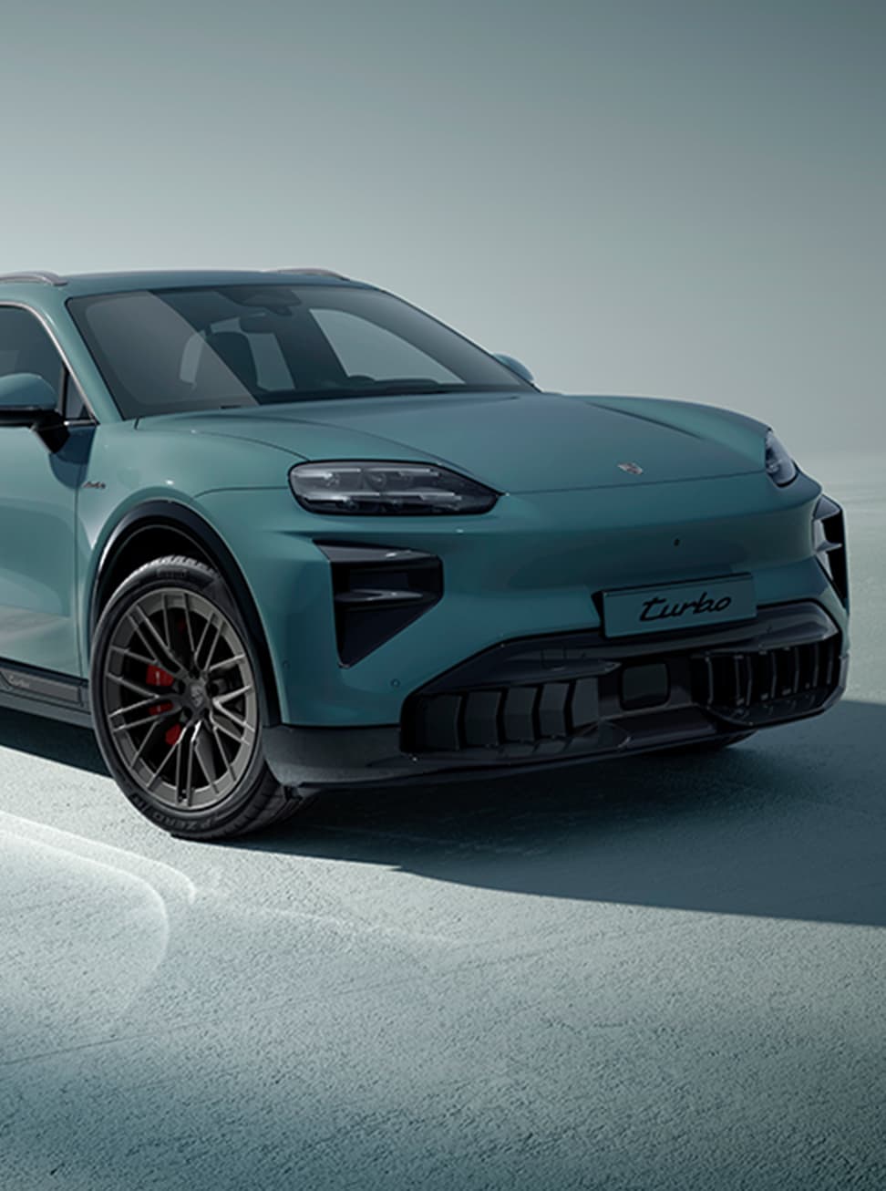 A Porsche Cayenne driving on an open road.